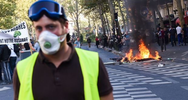Police fire tear gas and arrest 100 in Paris as yellow vests protest